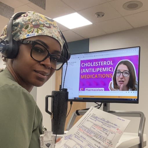A student looking back while studying level up RN videos